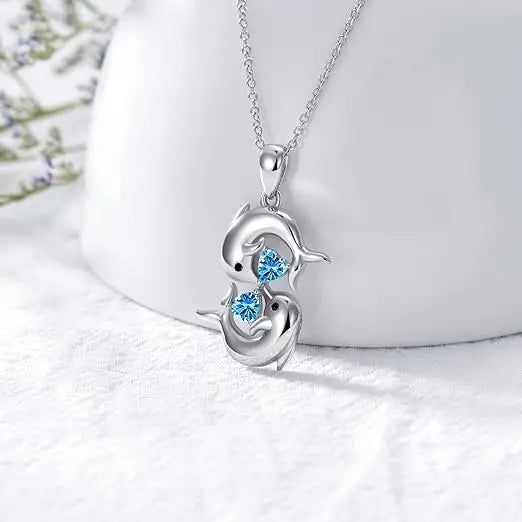 Collar de plata con doble delfín y cristal azul