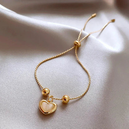 Pulsera en forma de corazón de ópalo melocotón bañada en oro